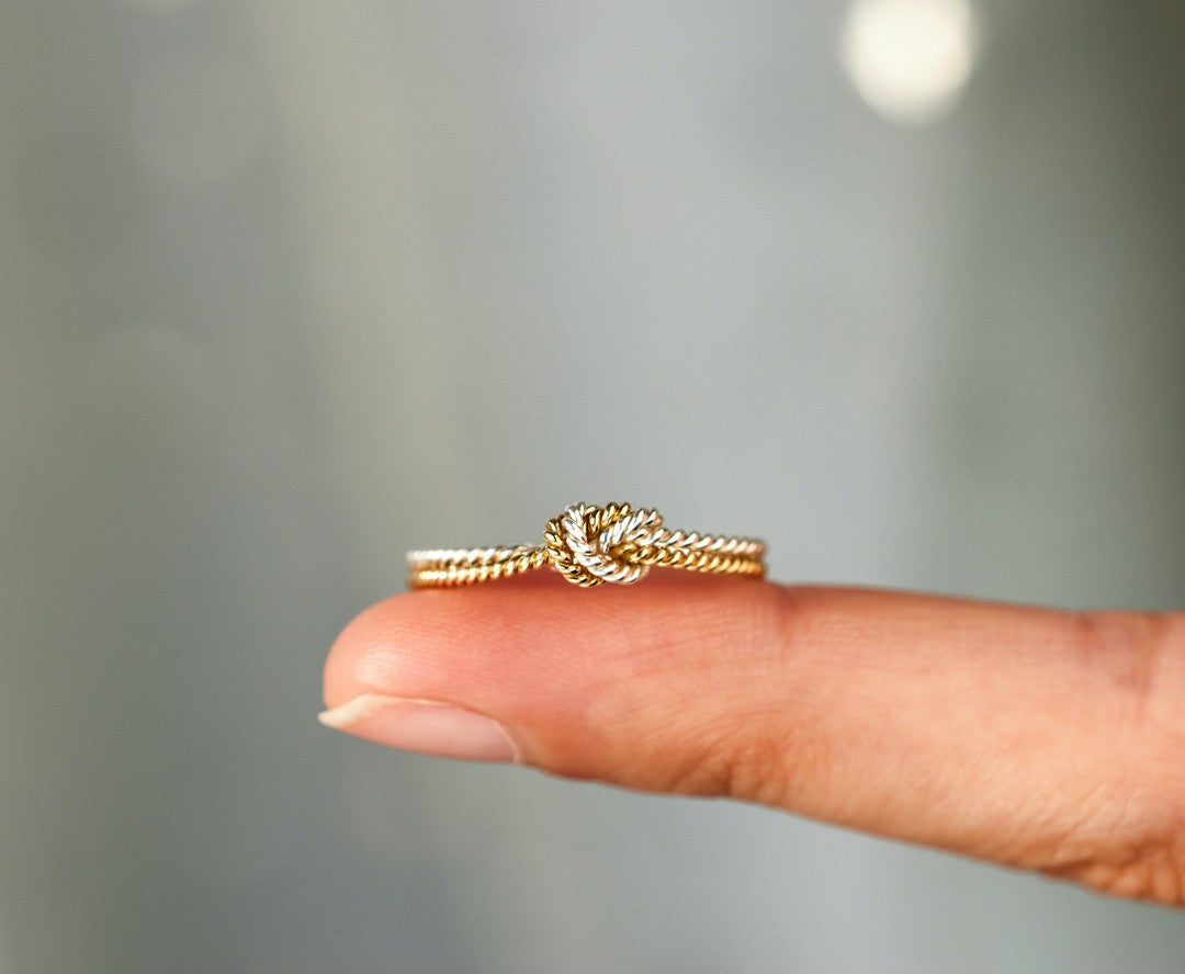 A handcrafted two-strand knot ring symbolizing the unbreakable bond between mothers and daughters.