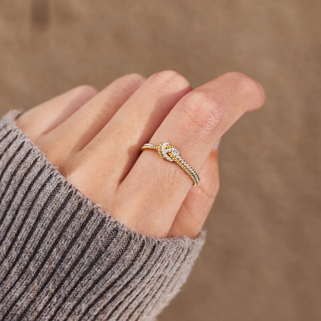 A handcrafted two-strand knot ring symbolizing the unbreakable bond between mothers and daughters.