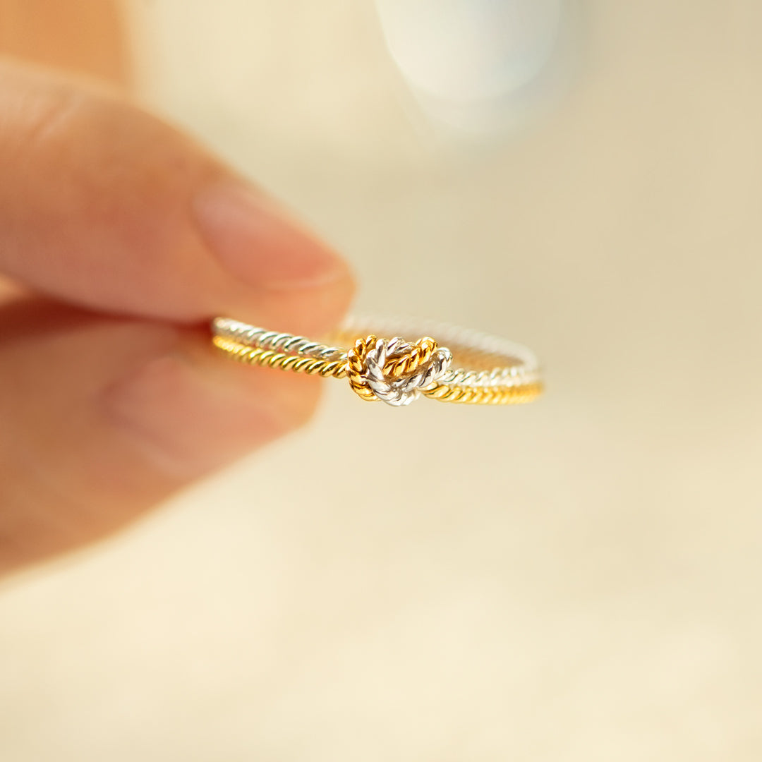 A handcrafted two-strand knot ring symbolizing the unbreakable bond between mothers and daughters.