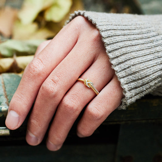 A handcrafted two-strand knot ring symbolizing the unbreakable bond between mothers and daughters.