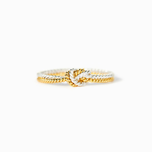 A handcrafted two-strand knot ring symbolizing the unbreakable bond between mothers and daughters.